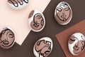 Happy Easter concept. Surreal faces on eggs on brown background. Art und Online style. Top view Flat lay