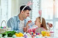 Happy easter!Dad and his little daughter together have fun while preparing for Easter holidays.On the table is a basket with Royalty Free Stock Photo