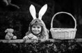 Happy easter day. Child with bunny ears. Child boy hunting easter eggs in backyard.