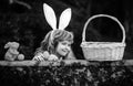 Happy easter day. Child with bunny ears. Kids boy hunting easter eggs in park.