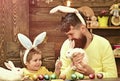 Happy Easter day. Father and son painting Easter eggs. Rabbits family with bunny ears. Royalty Free Stock Photo