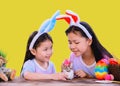 Happy Easter day. Kid with colorful eggs toy on yellow background. Happy and fun for celebrate on April Royalty Free Stock Photo