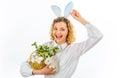 Happy Easter day. Smiling woman with white rabbit and basket with eggs. Royalty Free Stock Photo