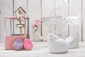 Happy Easter decoration for greeting card. Wooden bird, birdhouse, gingerbread Easter cookies in shape of Easter eggs on white ba