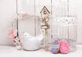 Happy Easter decoration for greeting card. Wooden bird, birdhouse, gingerbread Easter cookies in shape of Easter eggs on white ba