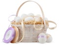 Happy Easter decorations, wicker basket with white eggs on straw nest, with rolls of bright colored ribbons. isolated on white Royalty Free Stock Photo