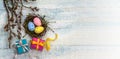 Gift boxes with ribbons. Happy Easter. Willow twigs. Holy Easter. Blue turquoise background. Easter eggs in the nest Royalty Free Stock Photo