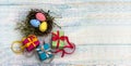 Gift boxes with ribbons. Happy Easter. Willow twigs. Holy Easter. Blue turquoise background. Easter eggs in the nest Royalty Free Stock Photo