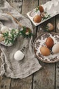 Happy Easter! Easter rustic still life. Natural easter eggs, blooming spring flowers, burlap and spoon  flat lay on rural wooden Royalty Free Stock Photo