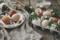 Happy Easter! Easter rustic still life. Natural easter eggs, blooming spring flowers, burlap and spoon on rural wooden table. Royalty Free Stock Photo