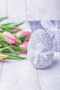 Happy Easter. Easter egg and pink tulips on a white background Royalty Free Stock Photo
