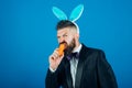 Happy easter egg. Smile easter man. Man in suit with bunny rabbit ears. Easter bunny dress. Royalty Free Stock Photo