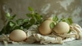 Happy Easter! Easter eggs on rustic table with green leaves. Natural eggs on textile and spring flowers . Moody atmospheric image