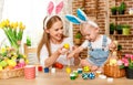 Happy easter! family mother and baby son paint eggs for holiday