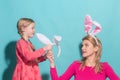 Happy Easter. Family mother and child daughter with bunny ears hare getting ready for holiday. Royalty Free Stock Photo