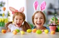 Happy easter! family mother and child daughter with ears hare getting ready for holiday Royalty Free Stock Photo
