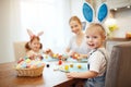 Happy easter! family mother and children paint eggs for holida