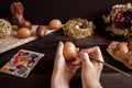 Happy easter. Female hands painting easter egg on the wooden table