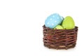 Happy Easter - few eggs on the wooden basket on the white background