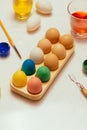 Happy Easter! Friends painting Easter eggs on table.