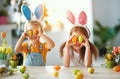 Happy easter! funny funny children with ears hare getting ready for holiday