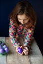 Happy easter. Girl and colored eggs in purple. Traditions of Easter. Teenager, girl 9 years old. Girl with a quack