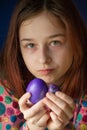 Happy easter. Girl and colored eggs in purple. Traditions of Easter. Teenager, girl 9 years old. Girl with a quack