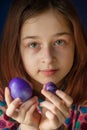 Happy easter. Girl and colored eggs in purple. Traditions of Easter. Teenager, girl 9 years old. Girl with a quack