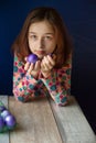 Happy easter. Girl and colored eggs in purple. Traditions of Easter. Teenager, girl 9 years old. Girl with a quack