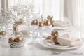 Happy Easter! Golden decor and table setting of the Easter table with white dishes of white color