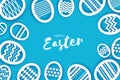 Happy Easter Greetings card. Eggs in paper cut style. Spring holidays on blue. Space for text. Royalty Free Stock Photo