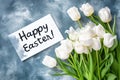 Happy Easter Handwritten Inscription on Card with White Tulips Satin Ribbon. Festive spring card Royalty Free Stock Photo