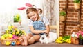 Happy easter! happy funny child girl playing with bunny Royalty Free Stock Photo