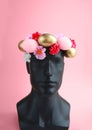 Happy Easter. The head of the mannequin is dressed in an Easter wreath of eggs and flowers Royalty Free Stock Photo
