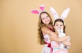 Happy easter. Holiday bunny girls with long bunny ears. Children bunny costume. Playful girls sisters celebrate easter Royalty Free Stock Photo