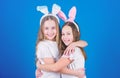 Happy easter. Holiday bunny girls with long bunny ears hug. Children easter bunny costume. Playful girls sisters Royalty Free Stock Photo