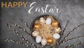 HAPPY EASTER holiday celebration backgroud greeting card with text - Easter nests with gold painted easter eggs and catkins on Royalty Free Stock Photo