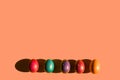 Happy Easter holiday concept. Set of handmade colorful eggs isolated on yellow background with shadow. Simple trendy minimal frame