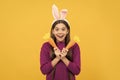 happy easter holiday. funny child in hare ears hold carrot. teenager girl wear rabbit costume Royalty Free Stock Photo