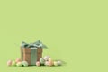Easter tiny eggs sweets and gift box on green background. Royalty Free Stock Photo