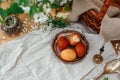 Happy Easter. Modern Easter eggs on vintage plate on rustic table with spring flowers,candle, basket. Stylish red and yellow Royalty Free Stock Photo