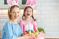 Happy easter! mother and child daughter with ears hare getting ready for holiday Royalty Free Stock Photo