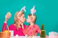 Happy easter. A mother and her daughter painting Easter eggs and kissing. Happy family preparing for Easter. Cute little Royalty Free Stock Photo