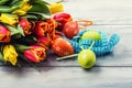 Happy easter. Multicolored spring tulips and Easter eggs. Spring and Easter decorations