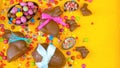 Happy Easter overhead with chocolate Easter eggs and decorations and copy space. Royalty Free Stock Photo