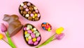 Happy Easter overhead with chocolate Easter eggs and decorations and copy space. Royalty Free Stock Photo