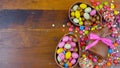 Happy Easter overhead with chocolate Easter eggs and decorations and copy space. Royalty Free Stock Photo