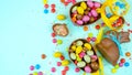 Happy Easter overhead with chocolate Easter eggs and decorations and copy space. Royalty Free Stock Photo