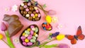 Happy Easter overhead with chocolate Easter eggs and decorations and copy space. Royalty Free Stock Photo