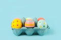 Happy Easter. Easter painted eggs in an open blue cardboard box Royalty Free Stock Photo